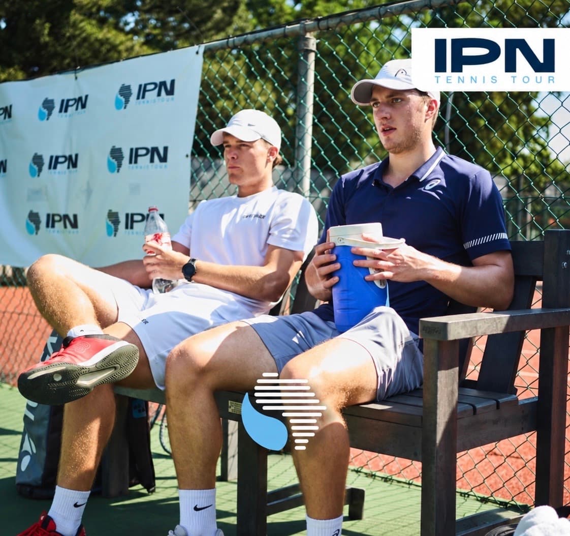 Two IPN Tennis Tour players seated courtside